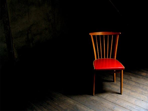 Empty chair in a dark room